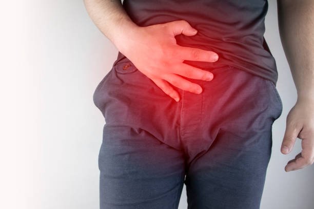 Image of a man with is hand over his stomach