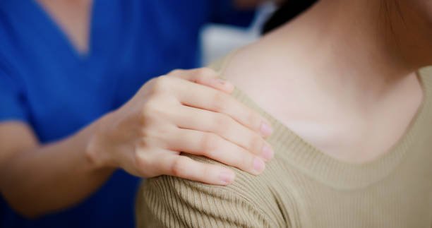 Image of woman massaging a woman's shoulder