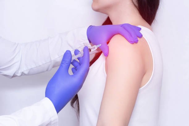 Image of getting an injection on her shoulder