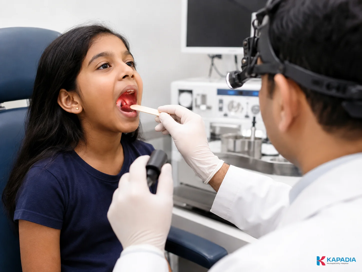 ENT surgeon examining a patient with tonsillitis at Kapadia Multispeciality Hospital, Goregaon, Mumbai