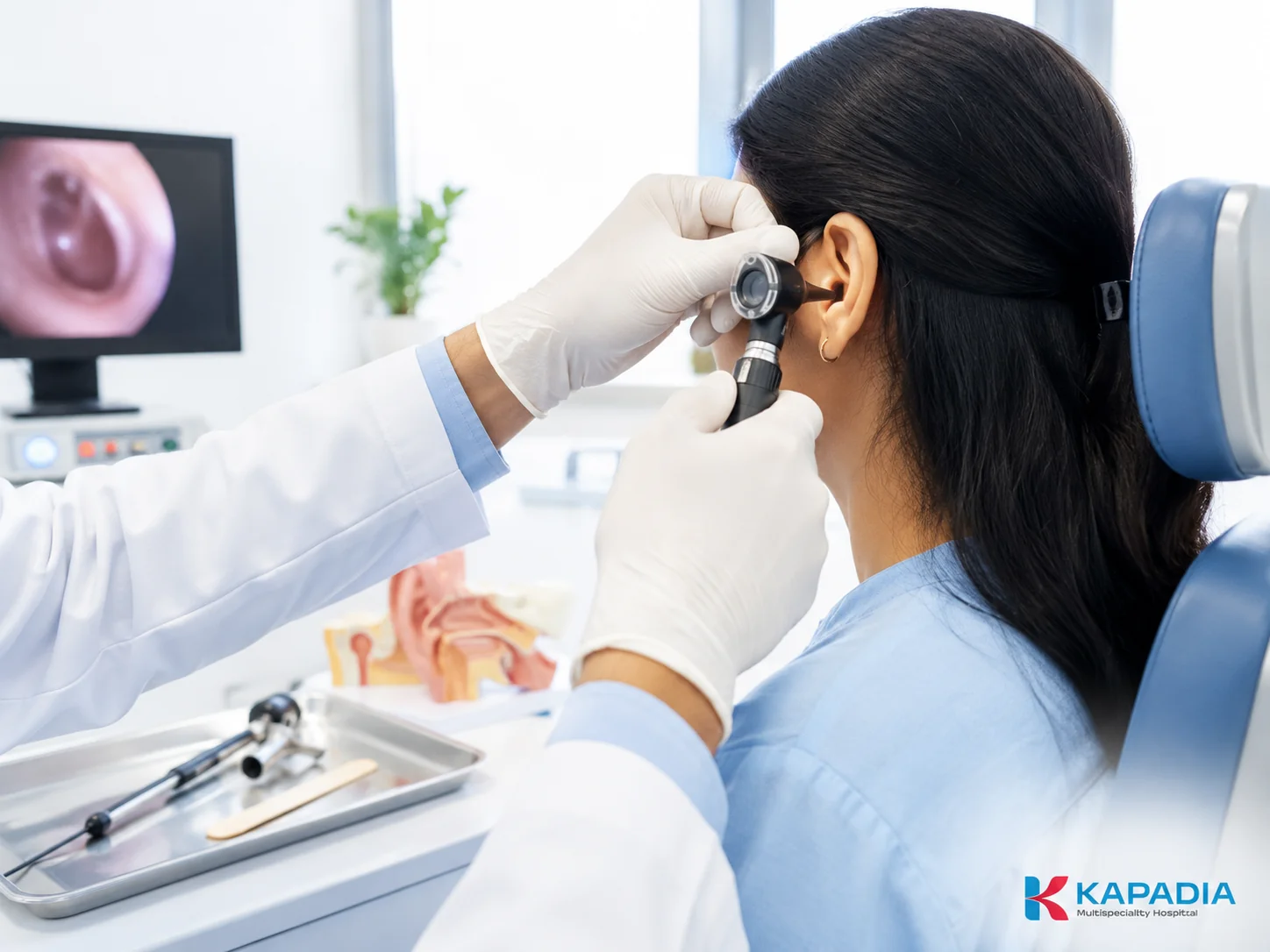 ENT specialist using an otoscope to examine a patient's ear at Kapadia Hospital, Mumbai