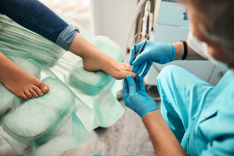 Clinician in gloves performing a medical pedicure with sterile instruments at Kapadia Hospital, Mumbai