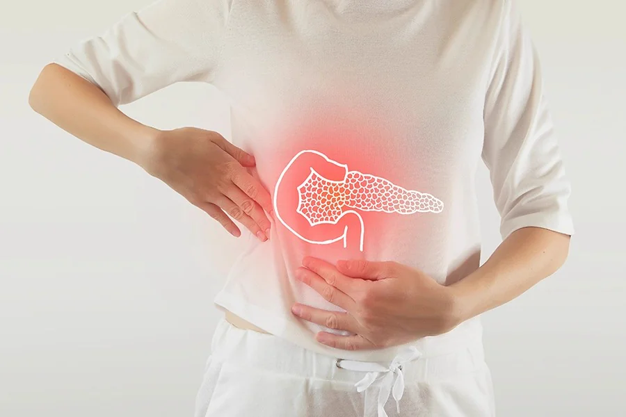 Person holding the abdomen with a highlighted bowel graphic indicating recurrent hernia pain - Kapadia Hospital, Mumbai